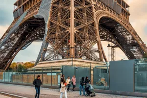 A group of adults and children walking below the Eiffel Tower in Paris, France. jigsaw puzzle