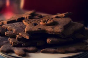 A stack of homemade gingerbread cookies on a ceramic plate, perfect for festive holiday treats. jigsaw puzzle