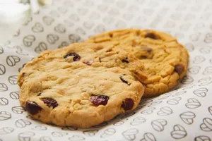 Close-up of tasty cranberry cookies on patterned paper, ideal for bakery design. jigsaw puzzle