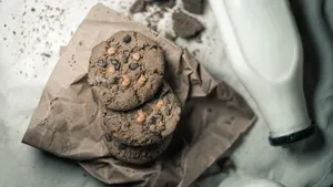 Tasty chocolate chip cookies with milk captured in a cozy, homemade setting. jigsaw puzzle