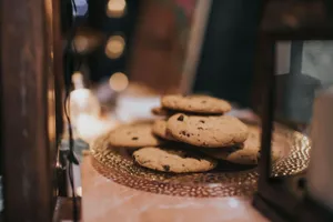Close-up of freshly baked chocolate chip cookies on a decorative tray, ready to enjoy. jigsaw puzzle