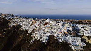 Stunning aerial view of Fira's iconic white architecture against the Aegean Sea. jigsaw puzzle