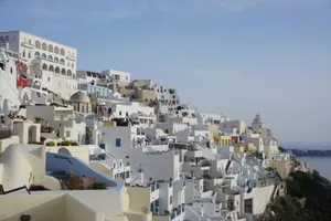 Scenic view of Santorini's whitewashed buildings and Aegean Sea from Thera, Greece. jigsaw puzzle