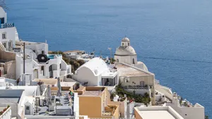 Aerial view of iconic whitewashed houses in Santorini with a stunning Aegean Sea backdrop, perfect for vacation imagery. jigsaw puzzle