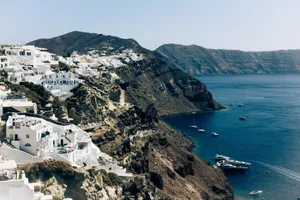 Breathtaking aerial view of Santorini's iconic white houses on cliffs overlooking the Aegean Sea. jigsaw puzzle