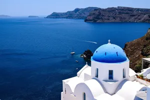 Experience the breathtaking beauty of Santorini's iconic blue-domed churches overlooking the Aegean Sea. jigsaw puzzle