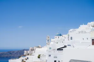 Bright and serene scene of Santorini's famous whitewashed structures against a clear blue sky. jigsaw puzzle