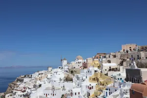 Explore the iconic whitewashed architecture of Oia, Santorini under a clear blue sky. jigsaw puzzle
