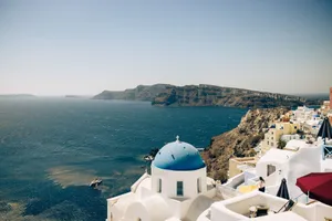 Capture the breathtaking sea view and charming architecture of Santorini with its iconic blue-domed buildings. jigsaw puzzle