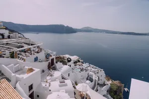 Stunning Santorini view capturing the iconic whitewashed buildings against a blue sea and sky. jigsaw puzzle