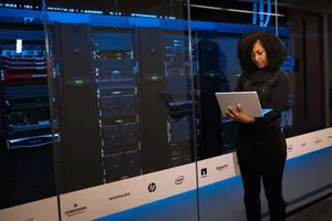 A female engineer using a laptop while monitoring data servers in a modern server room. jigsaw puzzle