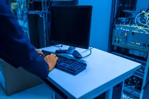 An IT professional operates a computer in a server room, managing network systems and connected devices. jigsaw puzzle