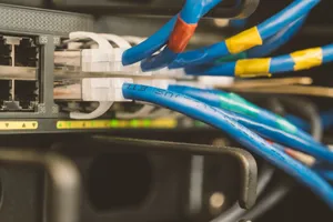 Network switch and blue ethernet cable with white tips connected to system for maintenance jigsaw puzzle