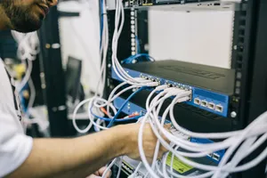 An IT professional configuring network cables in a server rack, focusing on Ethernet connections. jigsaw puzzle