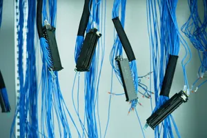 Close-up of blue ethernet cables hanging in a data center, highlighting technology connections. jigsaw puzzle