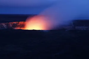A stunning nighttime view of a volcano eruption, with fiery lava glowing against the dark sky. jigsaw puzzle
