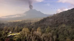 Dramatic aerial shot of a smoking volcano in Mexico with surrounding dense forest and rural scenery. jigsaw puzzle