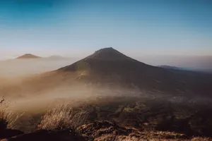 Breathtaking sunrise over Mount Sumbing with misty valleys, showcasing Indonesia's natural beauty. jigsaw puzzle