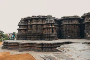 Explore the stunning stone carvings of Hoysaleshwara Temple, a famous Indian landmark and travel destination. jigsaw puzzle