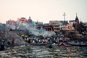 Vibrant view of Varanasi's ghats with crowds, boats, and traditional architecture by the Ganges River. jigsaw puzzle