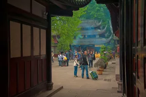 Visitors explore an ancient Asian temple courtyard surrounded by traditional architecture. jigsaw puzzle