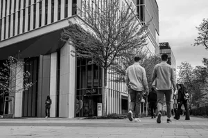 Black and white urban street scene with people walking near modern architecture. jigsaw puzzle