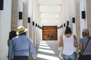 People strolling in a sunlit architectural corridor, showcasing modern Mexican design. jigsaw puzzle