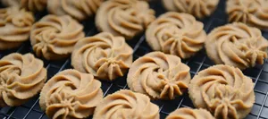 Freshly baked butter cookies arranged on a cooling rack, showcasing their intricate swirls. jigsaw puzzle