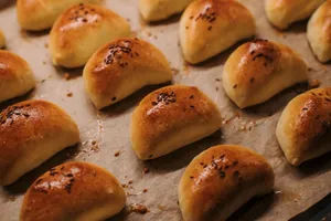 Delicious homemade dinner rolls with seeds on a baking tray, perfect for meals. jigsaw puzzle