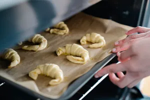 Close-up of freshly prepared croissants being placed in an oven. Perfect for food photography. jigsaw puzzle