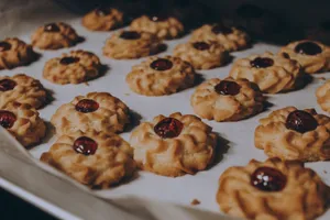 Close-up of homemade cookies topped with cherry jam on a baking sheet. jigsaw puzzle
