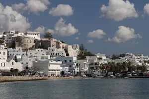 Explore the charming architecture of Naxos, Greece, framed by a bright blue sky and sparkling sea. jigsaw puzzle