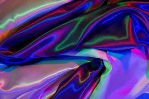 Colorful satin fabric displaying vibrant ripples and glossy textures under creative lighting. jigsaw puzzle