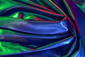 A colorful, shimmering iridescent fabric with vibrant, flowing textures and luminous gradients. jigsaw puzzle