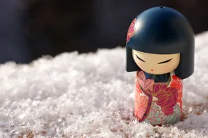 Close-up of a Kimmidoll figurine on snow-covered surface, exuding winter charm. jigsaw puzzle