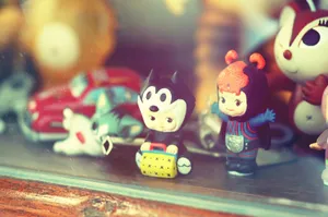Close-up of vintage toy figurines on a wooden shelf inside a glass display case. jigsaw puzzle