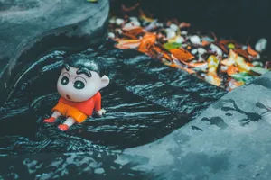 Toy figure of animated character in a dark water stream surrounded by fallen leaves. jigsaw puzzle