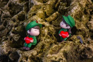Charming figurines holding love hearts on a textured mossy rock background. jigsaw puzzle