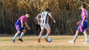 Youth soccer game with players in action outdoors, competing on a grassy field. jigsaw puzzle
