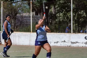 Two women playing field hockey outdoors in action with equipment. jigsaw puzzle