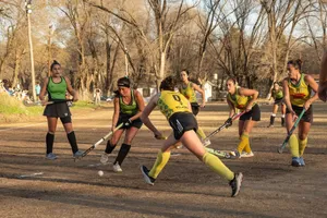 Dynamic scene of women playing field hockey during a competitive outdoor match. jigsaw puzzle