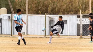 Players engaged in an amateur soccer match on a sandy field, highlighting the dynamic action of the game. jigsaw puzzle