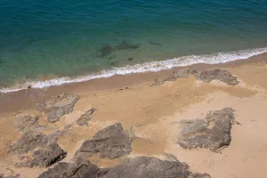 A tranquil sandy beach with rocky formations at Saint-Malo, Brittany, France. jigsaw puzzle
