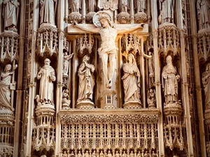 Detailed view of an ornate Gothic cathedral altar featuring intricate religious sculptures and carvings. jigsaw puzzle