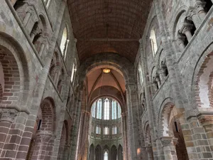 Majestic interior view of Mont Saint-Michel Abbey showcasing Gothic arches and stone architecture. jigsaw puzzle