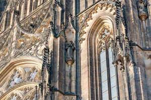 Detailed view of a Gothic cathedral's stone facade featuring ornate sculptures and window designs. jigsaw puzzle