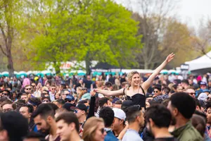 A lively outdoor music festival with diverse crowd enjoying the sunny day. jigsaw puzzle