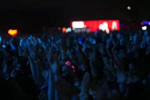A lively concert scene with a crowd of people enjoying the music at night. jigsaw puzzle