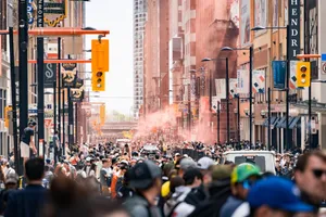 Dynamic urban scene with a bustling crowd on a city street during daytime. jigsaw puzzle