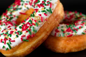 Appetizing donuts with festive red and green sprinkles on icing. Perfect for dessert indulgence. jigsaw puzzle